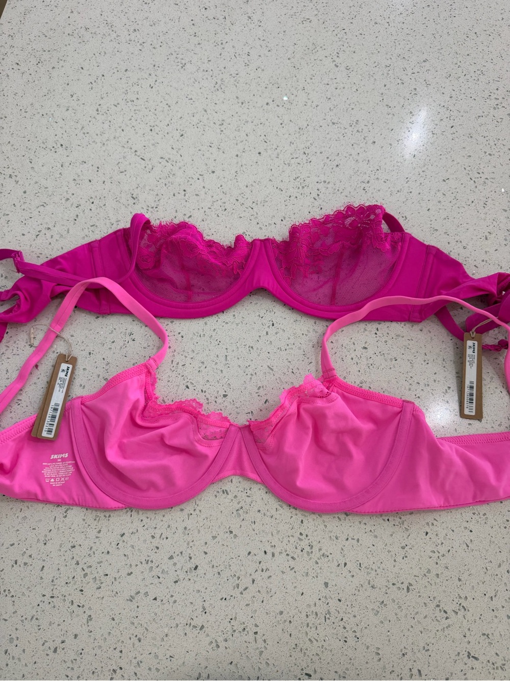 two SKIMS Bright Magenta & Hot Pink Lace Underwire Bras